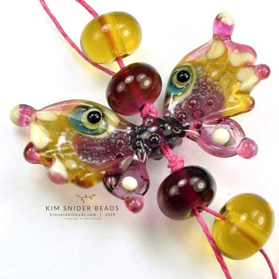 Kim Snider's beads are made with glass, metal and occasionally porcelain.
